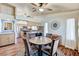 Bright dining area featuring wood floors, a round table, and a kitchen with granite countertops and stainless steel appliances at 2035 E Warm Springs Rd # 1019, Las Vegas, NV 89119