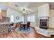 Charming dining space featuring a modern fireplace, wood floors, and ample natural light through shuttered windows at 2035 E Warm Springs Rd # 1019, Las Vegas, NV 89119