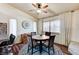 Inviting dining area with a ceiling fan, wood floors, and a round table set beneath shuttered windows and draped curtains at 2035 E Warm Springs Rd # 1019, Las Vegas, NV 89119
