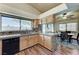 Bright kitchen features wood cabinets, dark countertops, mosaic backsplash, and stainless steel dishwasher at 2035 E Warm Springs Rd # 1019, Las Vegas, NV 89119