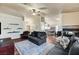Open-concept living room featuring hardwood floors, fireplace, comfortable couches, and kitchen access at 2035 E Warm Springs Rd # 1019, Las Vegas, NV 89119