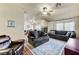 Spacious living room with hardwood floors, fireplace, ceiling fan, and comfortable couches at 2035 E Warm Springs Rd # 1019, Las Vegas, NV 89119