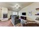Spacious living room with hardwood floors, fireplace, ceiling fan, and comfortable couches at 2035 E Warm Springs Rd # 1019, Las Vegas, NV 89119
