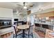 Open-concept living space combining a dining area, kitchen bar, living room, and fireplace, all with wood flooring at 2035 E Warm Springs Rd # 1019, Las Vegas, NV 89119