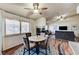 Spacious living area featuring a cozy seating area, fireplace, and adjacent dining space with shuttered windows at 2035 E Warm Springs Rd # 1019, Las Vegas, NV 89119