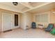 Relaxing covered front patio with tile floor, neutral walls, and comfortable seating at 2035 E Warm Springs Rd # 1019, Las Vegas, NV 89119