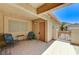 Relaxing covered front patio with tile floor, neutral walls, and comfortable seating at 2035 E Warm Springs Rd # 1019, Las Vegas, NV 89119