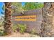 Sign for 2035 E. Warm Springs Rd, partially obscured by trees at 2035 E Warm Springs Rd # 1019, Las Vegas, NV 89119