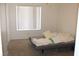 Simple bedroom featuring a futon and carpeted floor at 2201 E Dandelion St, Pahrump, NV 89048