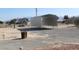 Metal carport in a gravel lot, offering covered parking or storage at 2201 E Dandelion St, Pahrump, NV 89048