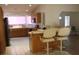 Open-concept kitchen with bar seating and stainless steel appliances at 2201 E Dandelion St, Pahrump, NV 89048