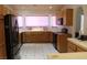 Bright kitchen with tile floor and white counters, bathed in light from multiple windows at 2201 E Dandelion St, Pahrump, NV 89048