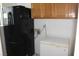 Small laundry area with refrigerator, chest freezer, and wooden cabinets at 2201 E Dandelion St, Pahrump, NV 89048