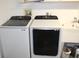 Laundry room featuring stacked washer and dryer and laundry sink at 2201 E Dandelion St, Pahrump, NV 89048