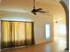 Living room with tiled floors, ceiling fan, and lots of windows at 2201 E Dandelion St, Pahrump, NV 89048