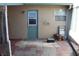 Covered back patio area with a door leading to the yard, featuring tiled pavers at 2201 E Dandelion St, Pahrump, NV 89048