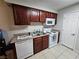 Functional kitchen with essential appliances, wood cabinets, and easy-to-clean tile floor at 2451 N Rainbow Blvd # 1123, Las Vegas, NV 89108