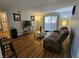 Cozy living room featuring hardwood floors, a plush sofa, and abundant natural light at 2451 N Rainbow Blvd # 1123, Las Vegas, NV 89108