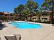Community pool with lounge chairs in a well-maintained area with mature trees at 2451 N Rainbow Blvd # 1123, Las Vegas, NV 89108