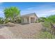 Backyard area with desert landscaping, covered patio and wrought iron fencing at 2548 Leighton Ave, Henderson, NV 89052
