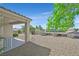 Backyard area with desert landscaping, a covered patio, and wrought iron fencing at 2548 Leighton Ave, Henderson, NV 89052