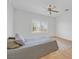 Spacious bedroom with natural light, ceiling fan, and a comfortable bed with decorative pillows at 2548 Leighton Ave, Henderson, NV 89052