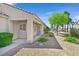 Inviting front entrance with a covered porch, desert landscaping and a secure screen door at 2548 Leighton Ave, Henderson, NV 89052