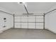 Spacious two car garage with painted walls and concrete flooring offers ample storage at 2548 Leighton Ave, Henderson, NV 89052