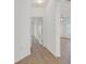 Light-filled hallway with wood flooring, leading to other rooms in the home at 2548 Leighton Ave, Henderson, NV 89052