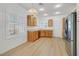 Well-lit kitchen with stainless steel appliances, wood cabinets, and wood style flooring at 2548 Leighton Ave, Henderson, NV 89052