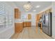 Spacious kitchen showcasing stainless steel appliances, wood cabinets, and neutral countertops at 2548 Leighton Ave, Henderson, NV 89052