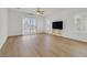 Open living room with a ceiling fan, wood floors, and sliding doors leading to the outdoor space at 2548 Leighton Ave, Henderson, NV 89052