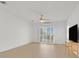Bright living room featuring wood floors, a ceiling fan, and sliding doors to the patio at 2548 Leighton Ave, Henderson, NV 89052