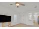 Neutral living room with wood floors, window shutters, and a view into the kitchen at 2548 Leighton Ave, Henderson, NV 89052