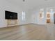 Bright and airy living room featuring wood floors, neutral paint, and a glimpse into the kitchen at 2548 Leighton Ave, Henderson, NV 89052
