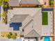 A bird's-eye view showcasing a roof, driveway, and backyard with a patch of artificial turf at 2625 Cattrack Ave, North Las Vegas, NV 89081