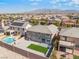 A bird's-eye view displays a backyard with a pool, artificial turf, and neighboring houses at 2625 Cattrack Ave, North Las Vegas, NV 89081