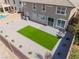 An aerial view showing a gravel backyard that includes a small, rectangular, artificial grass installation at 2625 Cattrack Ave, North Las Vegas, NV 89081