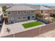 Spacious backyard featuring a small grass area, brick pavers, and minimal landscaping at 2625 Cattrack Ave, North Las Vegas, NV 89081