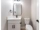 Powder room featuring a stylish mirror, modern vanity, and a toilet at 2625 Cattrack Ave, North Las Vegas, NV 89081