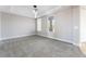 Neutral bedroom features a tray ceiling, two windows and plush carpet at 2625 Cattrack Ave, North Las Vegas, NV 89081