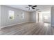 Spacious bedroom with wood-look floors and large windows, providing ample natural light at 2625 Cattrack Ave, North Las Vegas, NV 89081