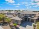 An aerial shot of a two-story home with neutral colors features a tile roof and well-maintained landscaping at 2625 Cattrack Ave, North Las Vegas, NV 89081