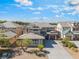 A lovely two-story house offers a tile roof, neutral colors and well-maintained landscaping and a spacious driveway at 2625 Cattrack Ave, North Las Vegas, NV 89081