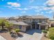A two-story home with neutral colors features a tile roof, well-maintained landscaping, and a spacious driveway at 2625 Cattrack Ave, North Las Vegas, NV 89081
