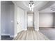 Open foyer featuring wood-look floors, neutral paint, and modern lighting at 2625 Cattrack Ave, North Las Vegas, NV 89081