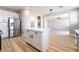 A kitchen island with white cabinets, stainless steel appliances, and an open floor plan at 2625 Cattrack Ave, North Las Vegas, NV 89081