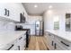 Modern kitchen featuring white cabinets, stainless steel appliances, and quartz countertops at 2625 Cattrack Ave, North Las Vegas, NV 89081