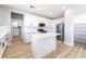 A kitchen featuring a center island, white cabinets, and stainless steel appliances at 2625 Cattrack Ave, North Las Vegas, NV 89081