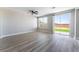 A spacious living room featuring luxury vinyl plank flooring, a ceiling fan, and access to the backyard at 2625 Cattrack Ave, North Las Vegas, NV 89081